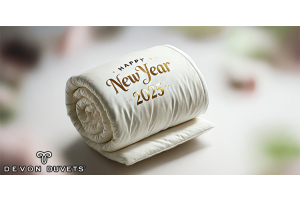 Happy new year 2025 duvet rolled up on a bed Devon Duvets.