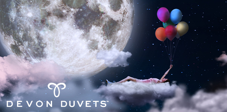 A dreamy night-time scene featuring a person floating on a fluffy cloud, holding colourful balloons, with a large glowing moon in the background and the Devon Duvets logo displayed below.