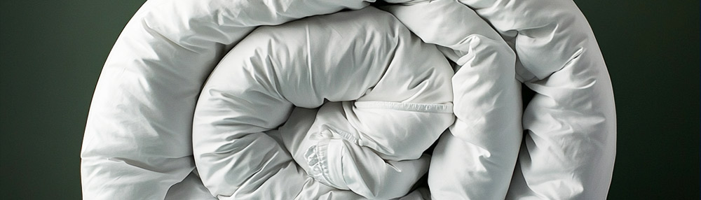 Close-up of a synthetic duvet filling, highlighting the environmental impact of polyester bedding.