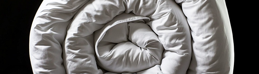 Down duvet folded neatly, demonstrating lightweight and soft bedding options.