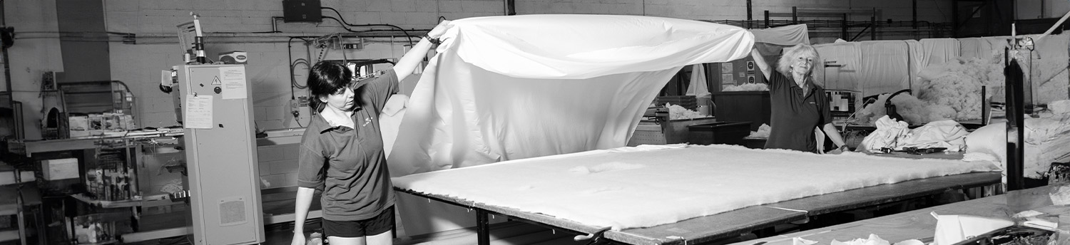 Inside the Devon Duvets workshop in Devon, where skilled seamstresses handcraft duvets with precision and care.