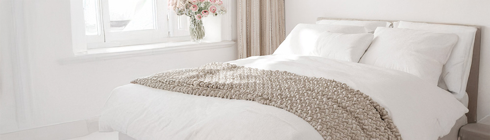 Minimalist bedroom featuring a modern duvet on a neatly made bed.