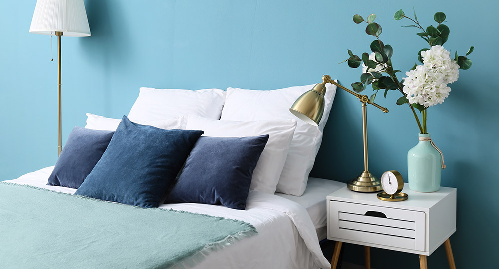 Blue bedroom with cosy bedding and minimal decor