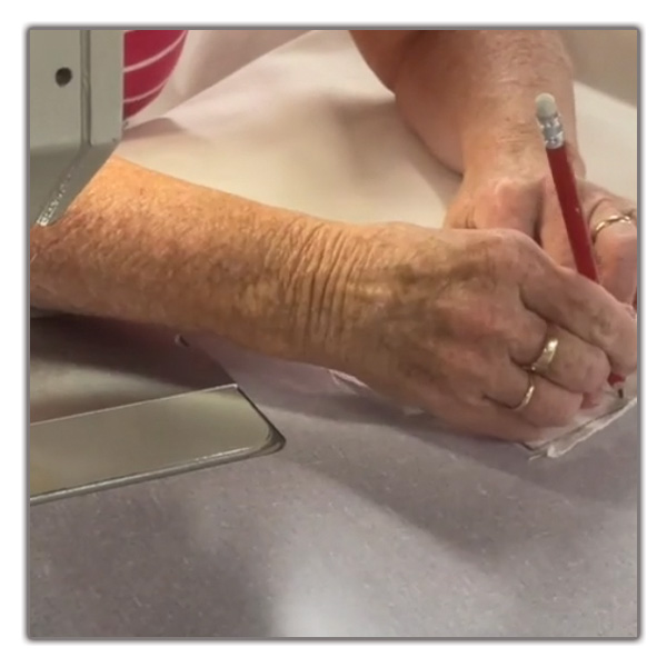 Skilled seamstress crafting a cotton calico bag in Devon Duvets workshop