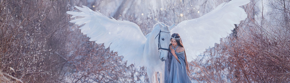 A serene winter fantasy scene of a woman dressed in flowing blue robes with a delicate silver headpiece, standing close to a majestic white horse with large angelic wings. Snow sparkles in the air, and frosted branches frame the magical moment.